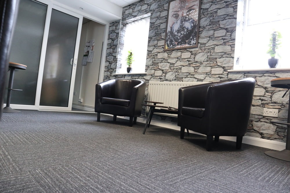 Occupational Health Waiting Area with small black seats and coffee table