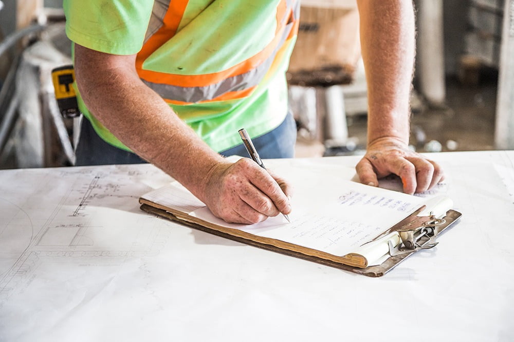 Image showing construction man writing on clipboard