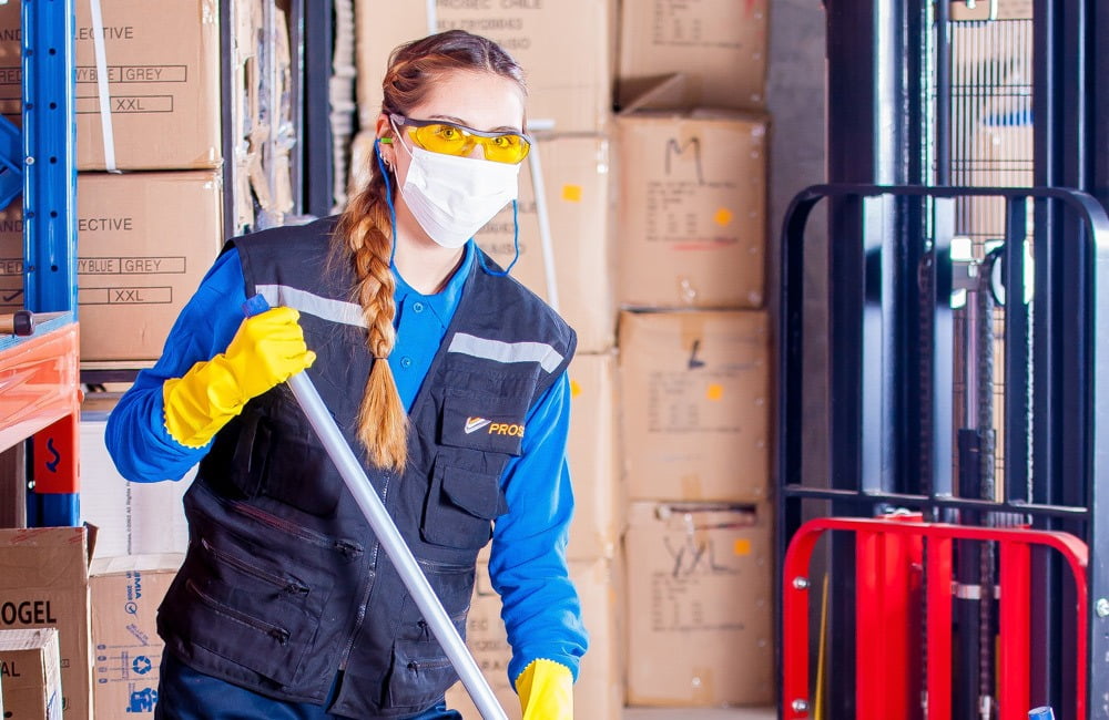 Woman cleaning warehouse