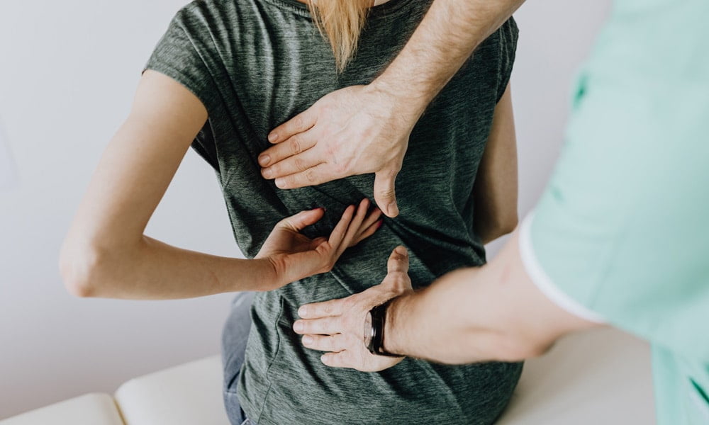 photo of woman suffering from back pains