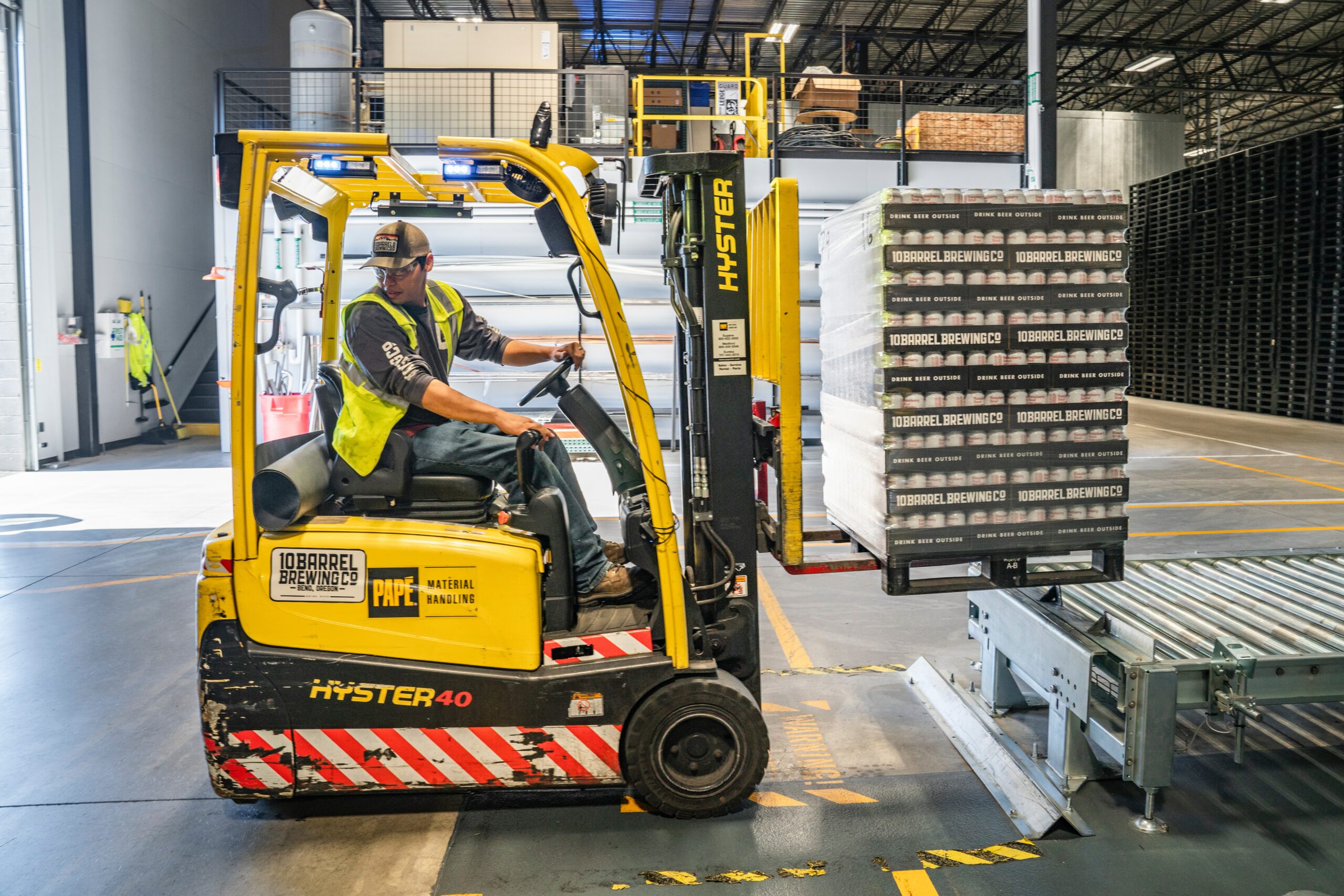 Warehouse employee driving a trolley
