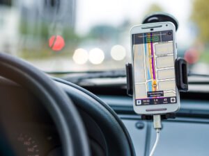 Mobile phone inside a car with GPS instructions on screen