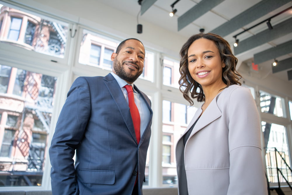 Young male and female employees wearing suits seeming confident at the workplace.