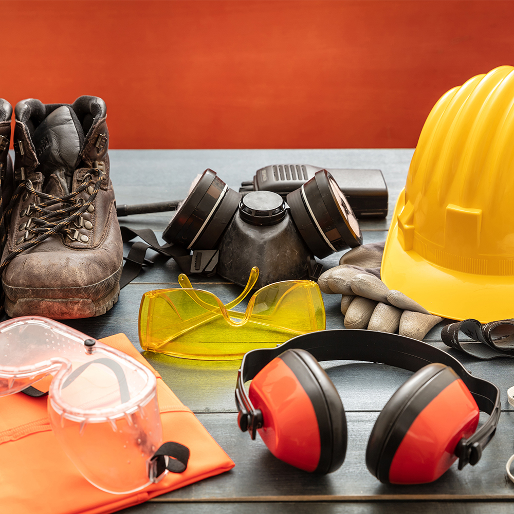 Construction work PPE up close-helmet, boots, hearing protection, etc.