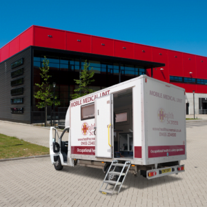 Occupational health mobile unit parked in front of an industrial estate