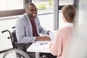 Disabled employee having a conversation with colleague