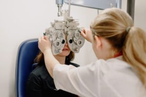 Doctor performing a vision screening test on female patient