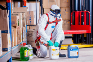 Worker wearing protective equipment while handling dangerous liquids resized