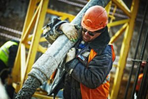 Construction worker carrying construction materials