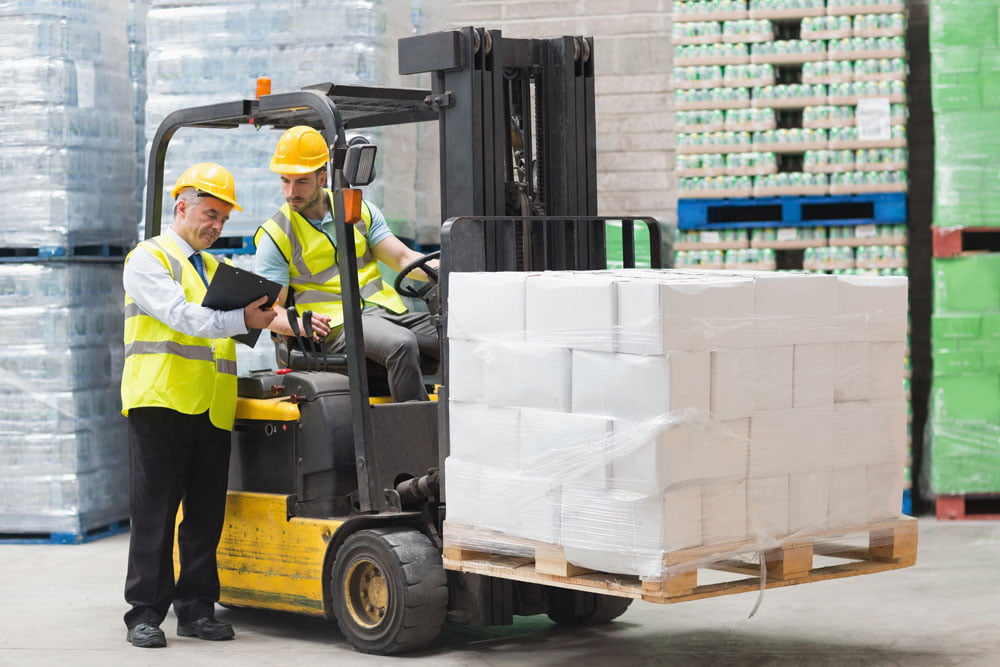 Forklift driver having a discussion with his manager
