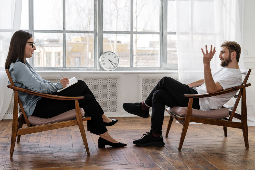 Counsellor having a conversation with a male patient