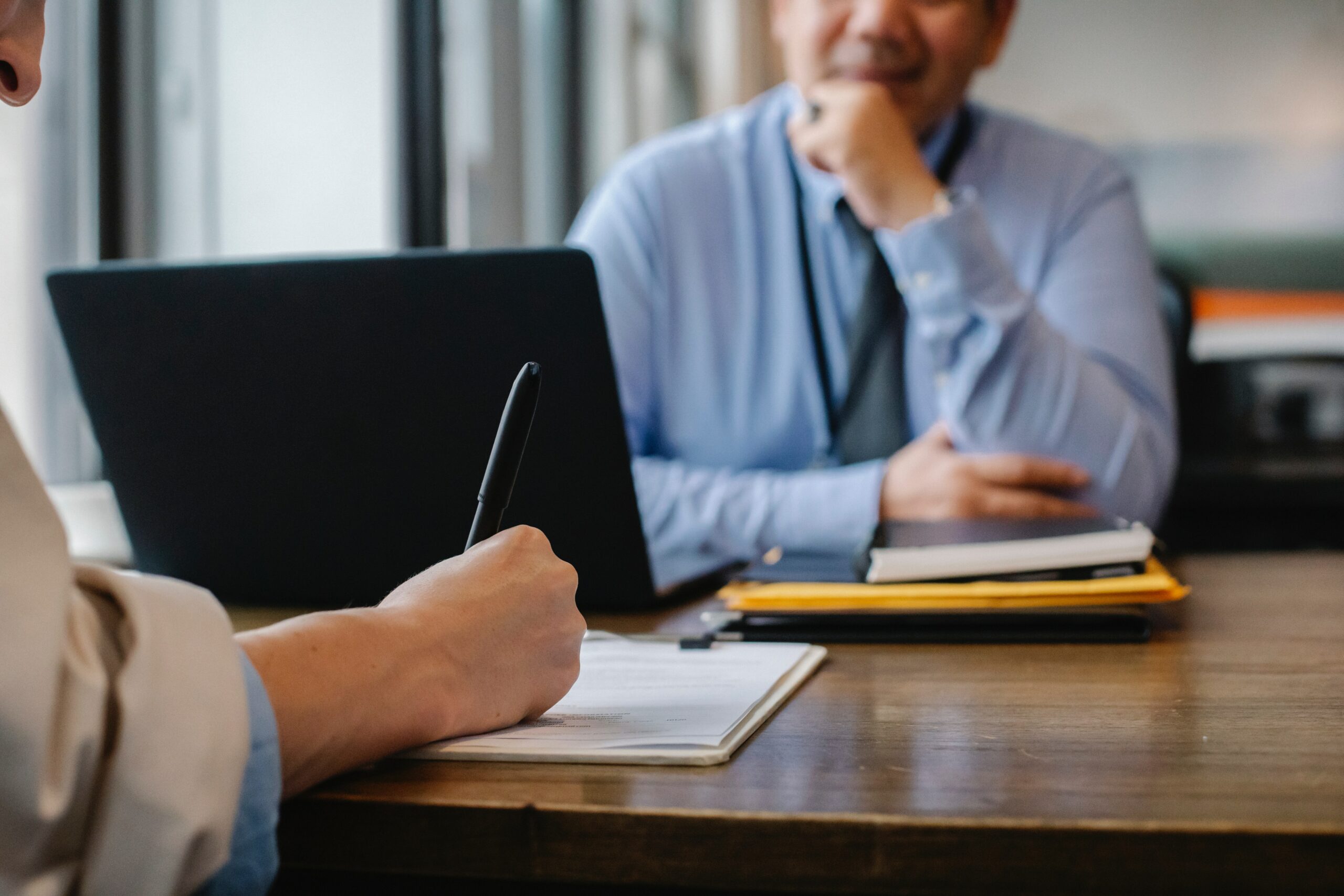 Employer and employee having a conversation at desk