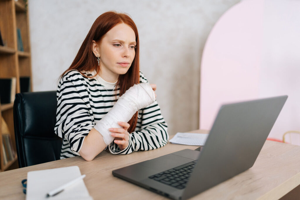 a lady with hands in cast working
